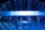 tech forward image of light prisms in a dark room, casting a blue hue speckled with light
