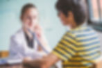 Young female Doctor listening to a young male student's heart