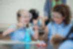 Two female gradeschool students performing a science experiment