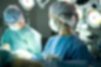 Two doctors performing operating in a surgical suite