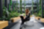 Female employee working within the indoor botanical lounge within her office